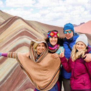 Turista celebrando la llegada a la cumbre de la Montaña de 7 Colores.